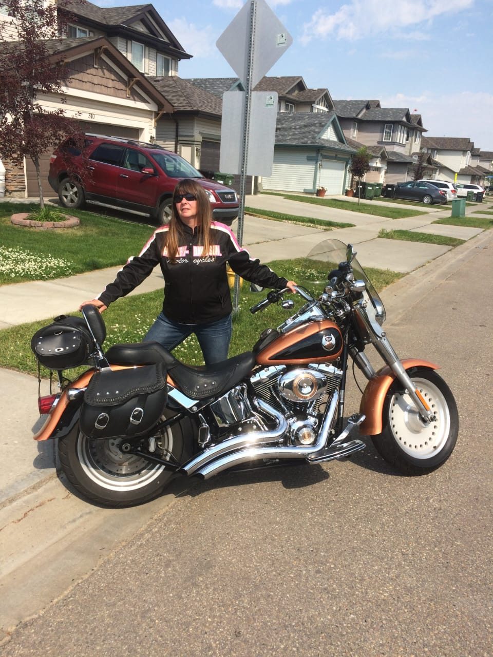 Dawn standing with her Harley-Davidson motorcycle