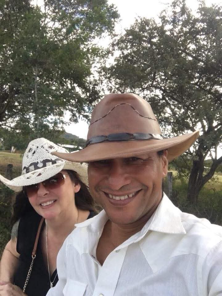 Dawn and Nolberto in cowboy hats outdoors in Guanacaste