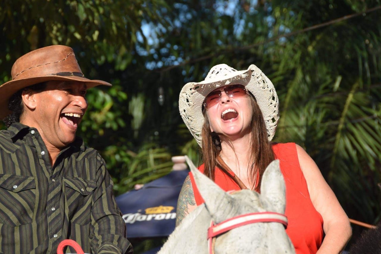 Dawn and Nolberto laughing on horseback