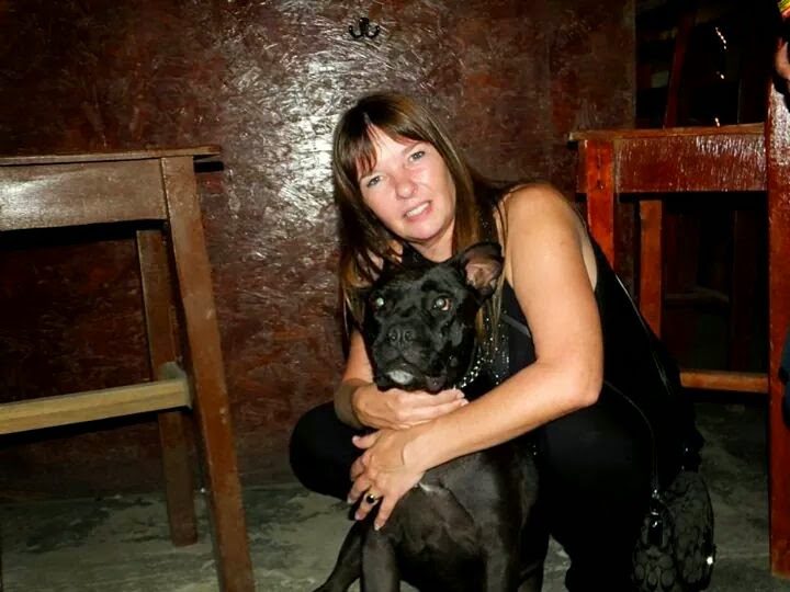 Dawn hugging a black rescue dog