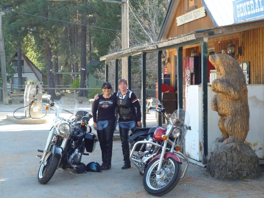 Dawn and a friend with their motorcycles outside a trading post