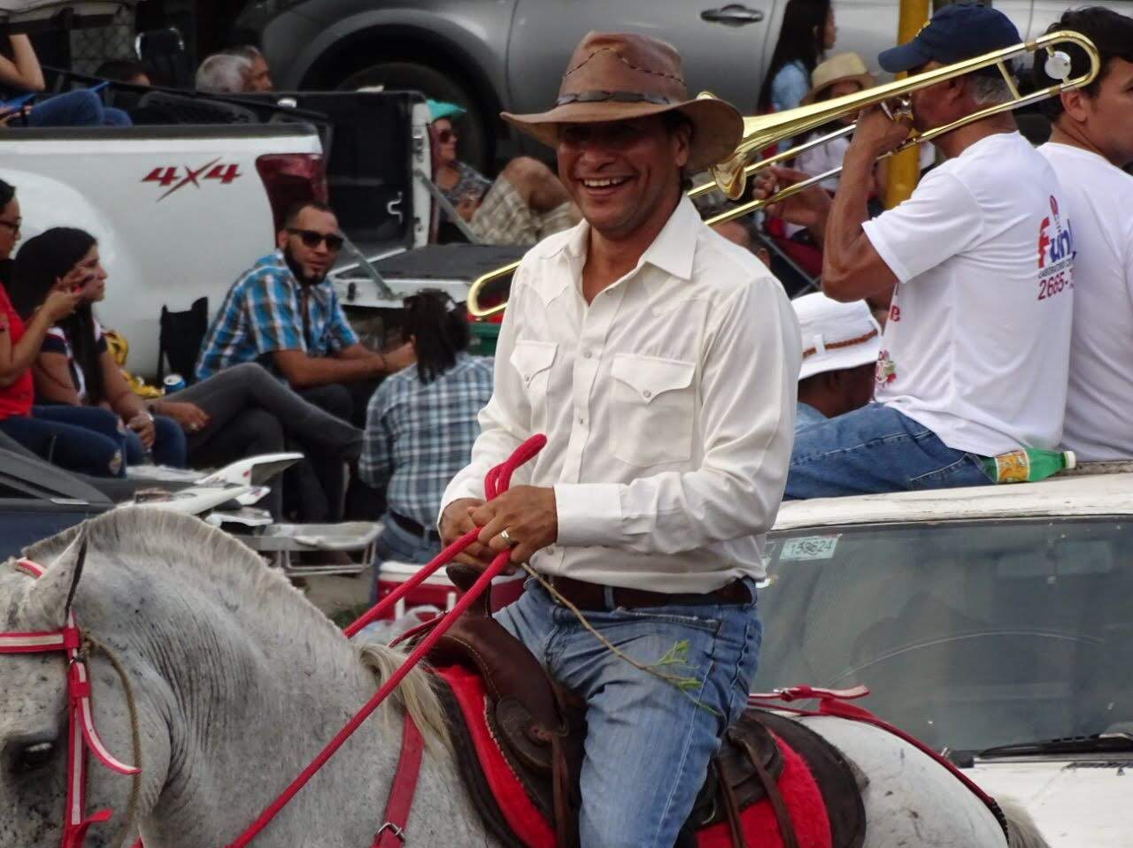 Nolberto riding a white horse in a tope parade